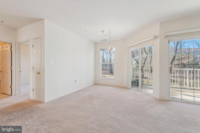 interior space with baseboards, an inviting chandelier, and carpet floors