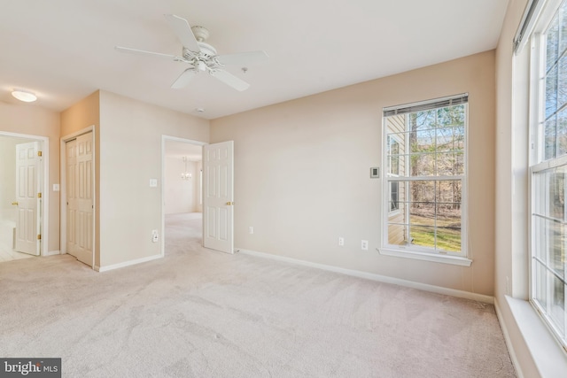 unfurnished bedroom featuring a ceiling fan, carpet, and baseboards