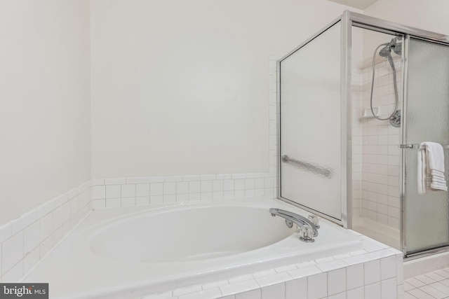 bathroom with a garden tub and a stall shower