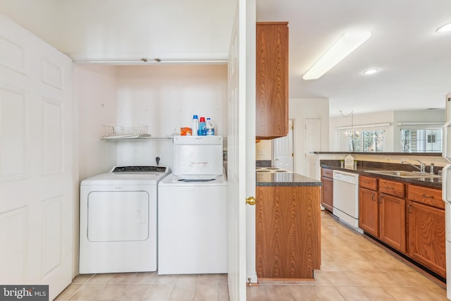 clothes washing area featuring light tile patterned floors, laundry area, recessed lighting, a sink, and washing machine and dryer