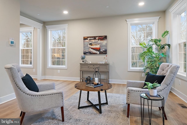 sitting room with recessed lighting, baseboards, and light wood finished floors