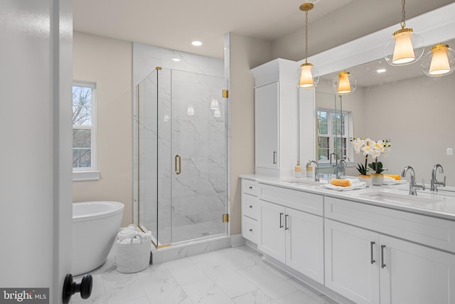 full bath featuring marble finish floor, a marble finish shower, and a sink