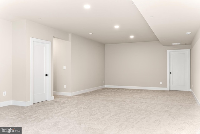 unfurnished room featuring light carpet, baseboards, visible vents, and recessed lighting