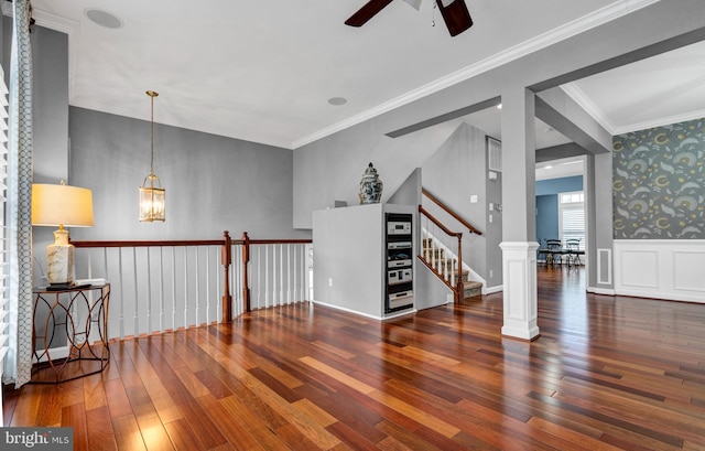 spare room featuring a wainscoted wall, crown molding, and hardwood / wood-style floors