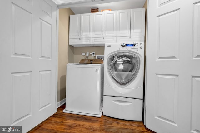 laundry area with dark wood-type flooring, cabinet space, and independent washer and dryer