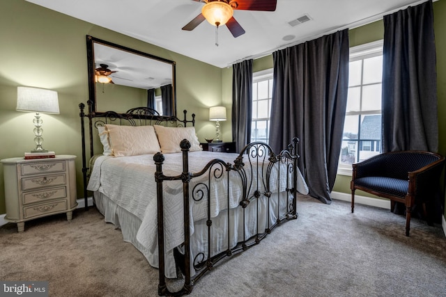 bedroom featuring a ceiling fan, baseboards, visible vents, and carpet flooring