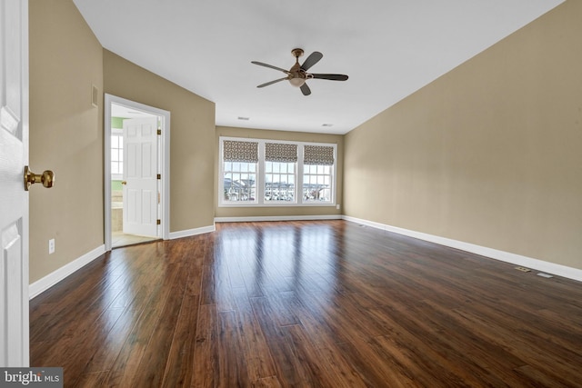 unfurnished living room with ceiling fan, baseboards, and dark wood-style flooring