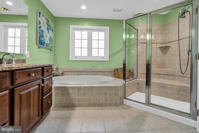 full bathroom featuring visible vents, tile patterned floors, a garden tub, vanity, and a shower stall