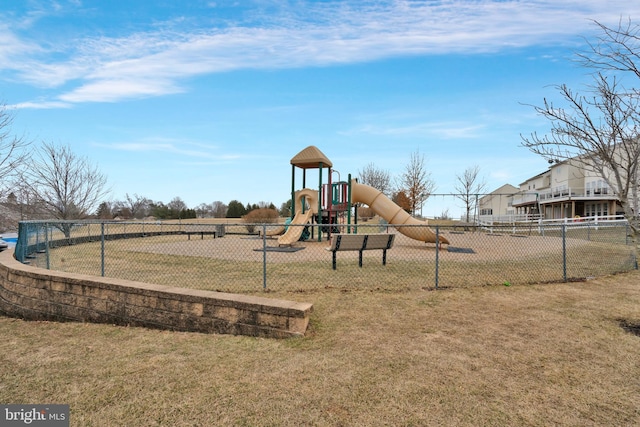 community play area with fence and a yard