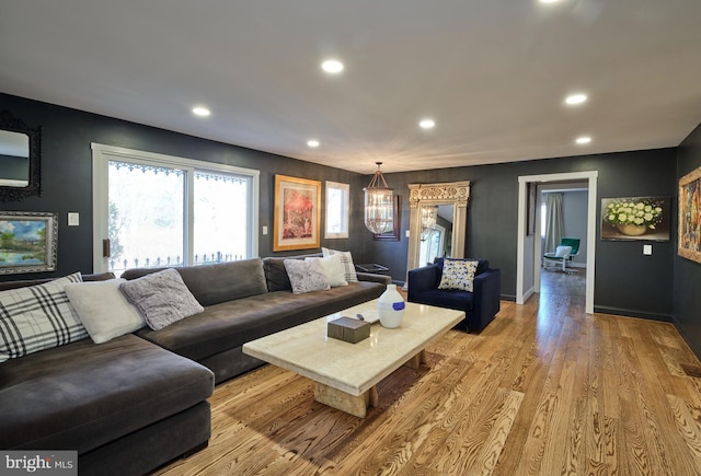 living room with light wood-type flooring, baseboards, and recessed lighting