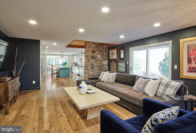 living room with light wood-style floors and recessed lighting