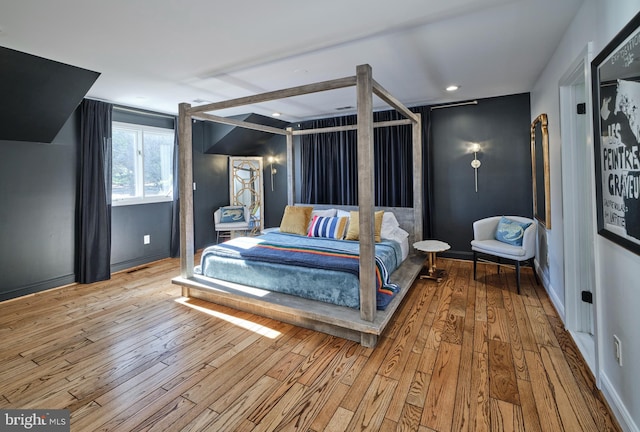 bedroom featuring hardwood / wood-style floors and baseboards