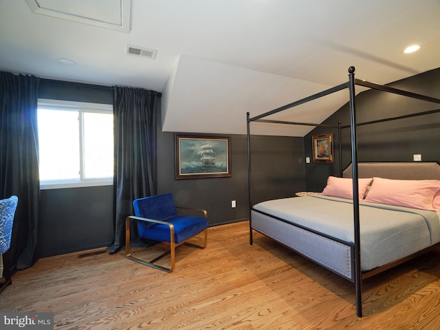 bedroom with light wood-type flooring, recessed lighting, visible vents, and lofted ceiling