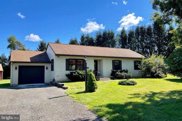 ranch-style home featuring a front lawn, an attached garage, and gravel driveway