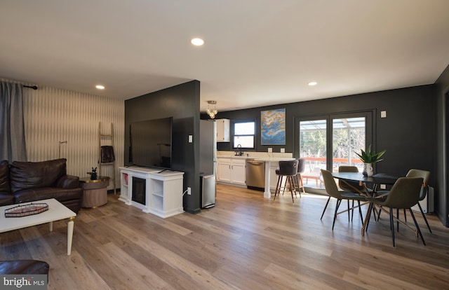 living room featuring light wood-style floors, a fireplace, and recessed lighting