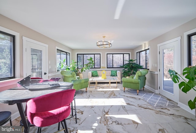 sunroom with an inviting chandelier