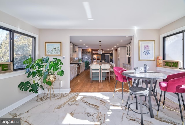 dining room featuring recessed lighting, marble finish floor, and baseboards