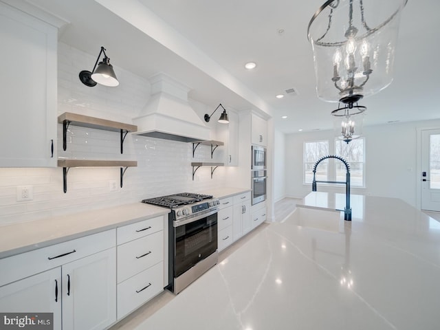 kitchen with stainless steel appliances, a sink, custom exhaust hood, and open shelves