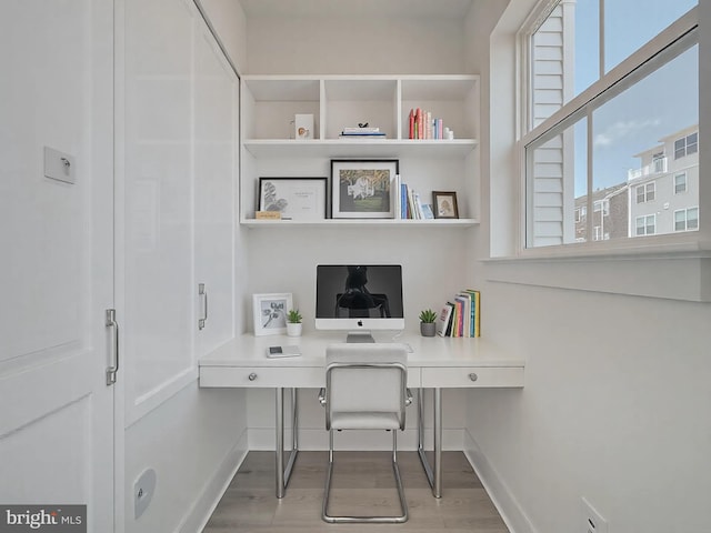 home office featuring wood finished floors and baseboards