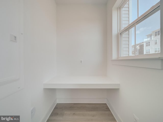 interior space featuring baseboards and wood finished floors