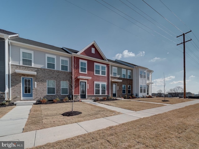 townhome / multi-family property featuring brick siding