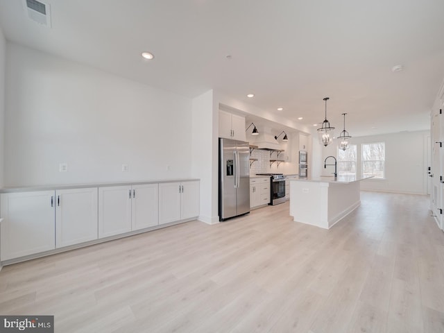 kitchen with open shelves, stainless steel appliances, light countertops, custom range hood, and white cabinets