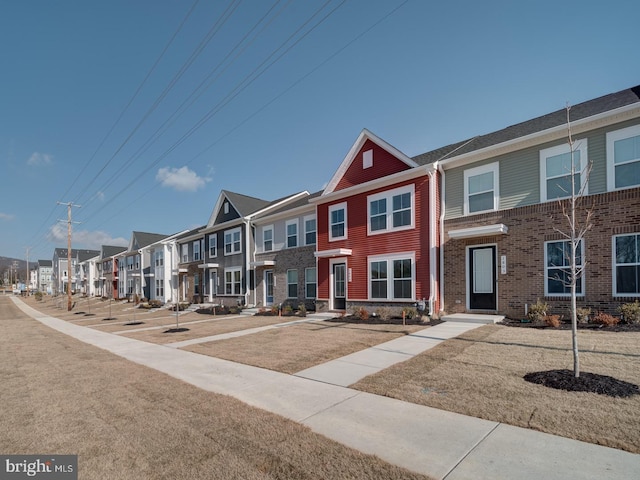 multi unit property featuring brick siding and a residential view