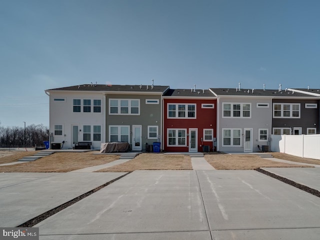 exterior space featuring fence and cooling unit