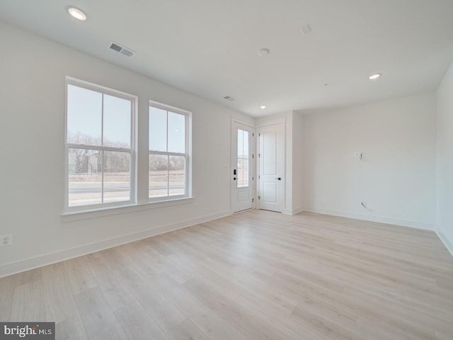 unfurnished living room featuring light wood-type flooring, baseboards, visible vents, and recessed lighting