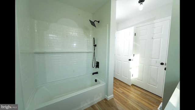 bathroom with wood finished floors and shower / tub combination