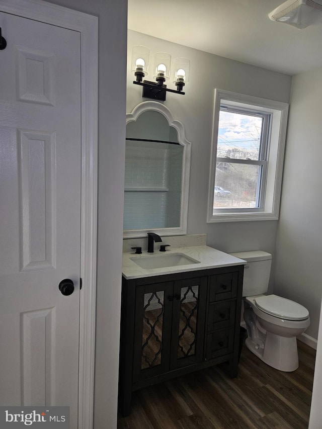 bathroom featuring vanity, toilet, and wood finished floors