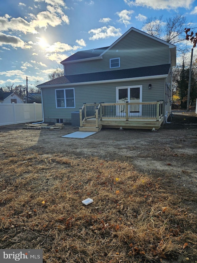 back of house with fence and a deck