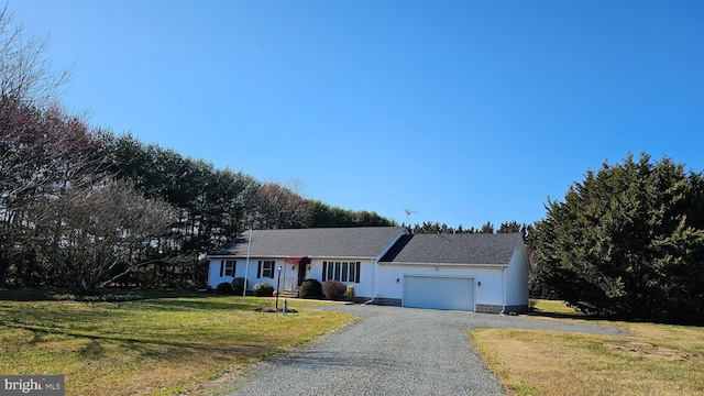 ranch-style home with gravel driveway, an attached garage, and a front lawn