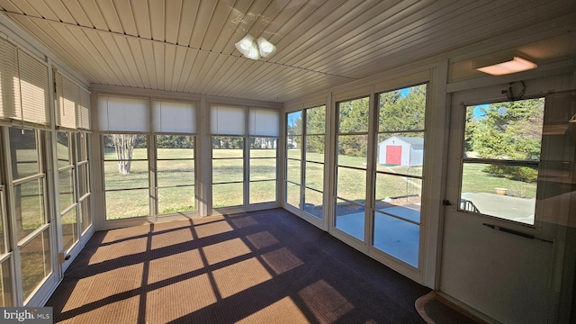 unfurnished sunroom with wood ceiling