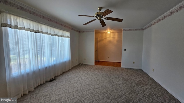 unfurnished room featuring ceiling fan, baseboards, ornamental molding, and light colored carpet