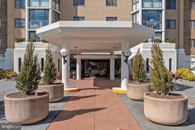 view of exterior entry with brick siding