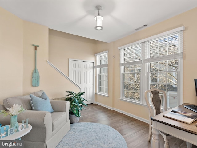 office area featuring visible vents, baseboards, and wood finished floors