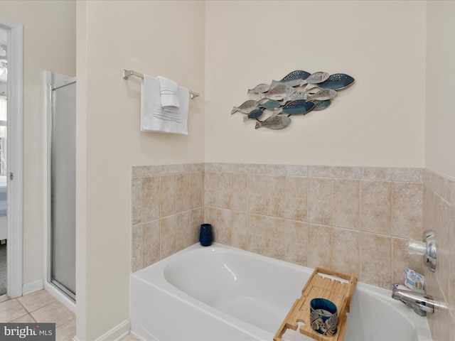 bathroom featuring tile patterned floors, a shower stall, and a garden tub