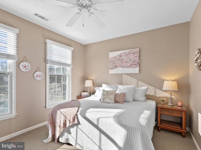 bedroom featuring visible vents, carpet flooring, baseboards, and ceiling fan