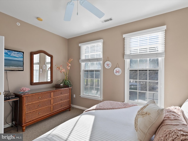 carpeted bedroom featuring visible vents, ceiling fan, and baseboards