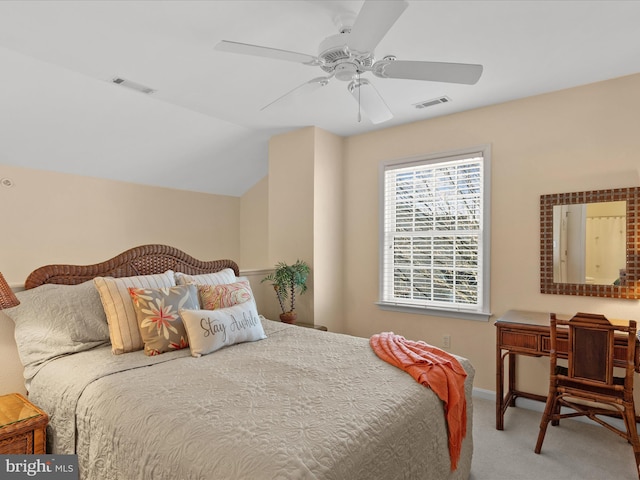 carpeted bedroom featuring visible vents, a ceiling fan, and lofted ceiling