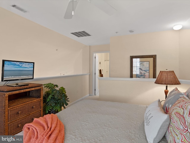 carpeted bedroom with a ceiling fan, visible vents, and baseboards