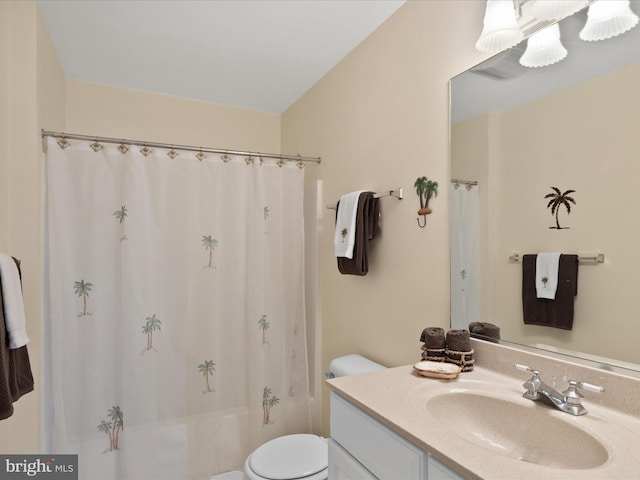 bathroom featuring vanity, toilet, and shower / bath combo