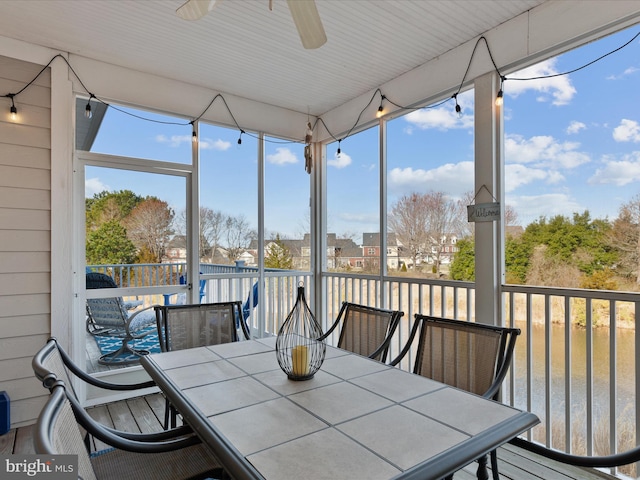 sunroom featuring ceiling fan