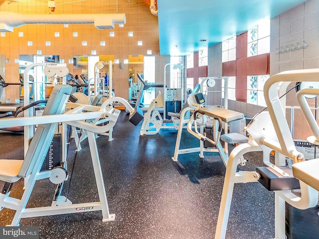 exercise room featuring tile walls