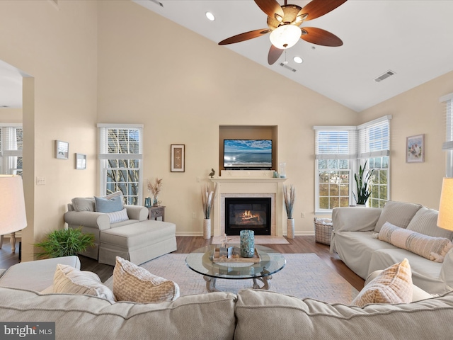 living room featuring a wealth of natural light, visible vents, and wood finished floors