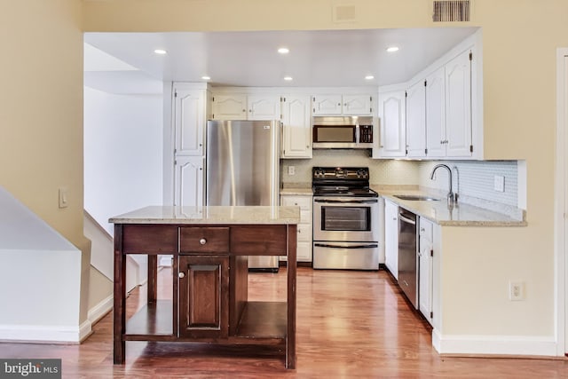 3101 New Mexico Ave NW Unit 847, Washington, DC 20016 - kitchen featuring white cabinetry, visible vents, appliances with stainless steel finishes, and a sink