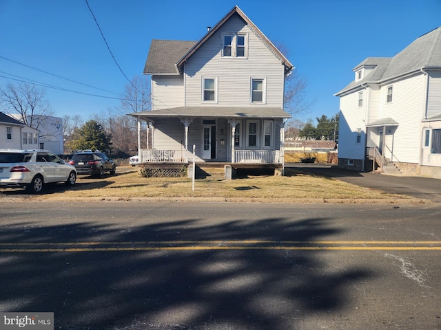 view of front of house featuring a shingled roof and covered porch