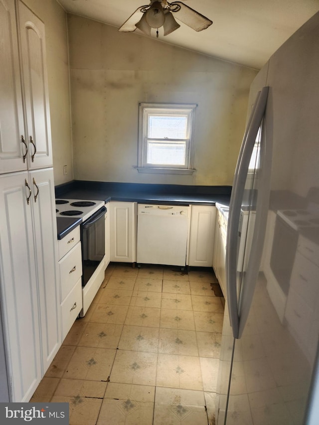 kitchen featuring dark countertops, white dishwasher, white cabinets, and electric stove