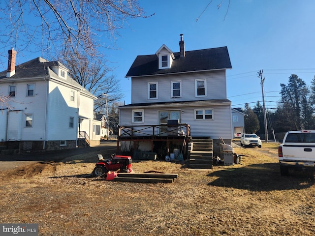 back of house with a chimney